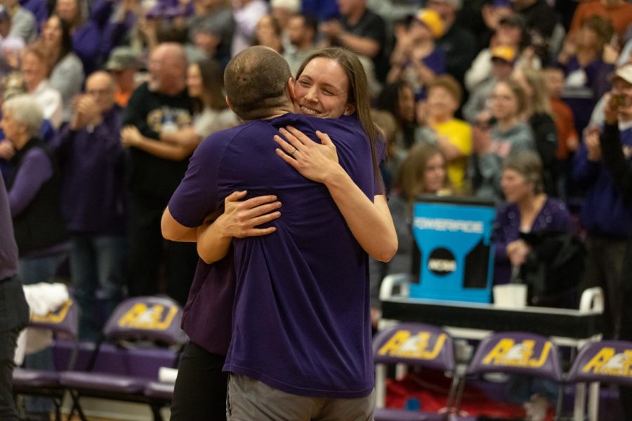 Head+Coach+Kari+Pickens+embraces+her+husbands+hug+after+winning+the+Midwest+Region.