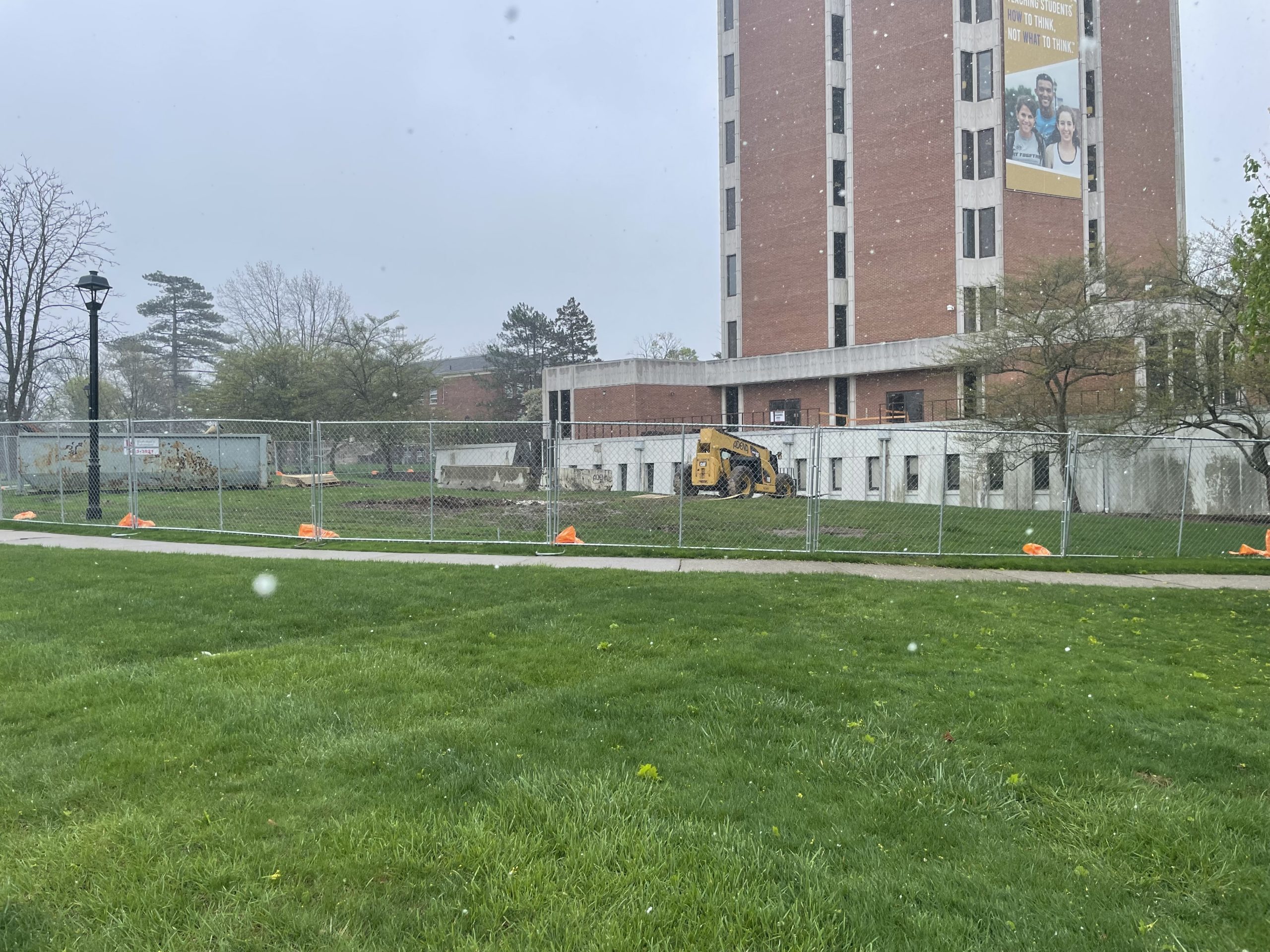 Construction is underway on the new library cafe with a fence put around the back library patio.