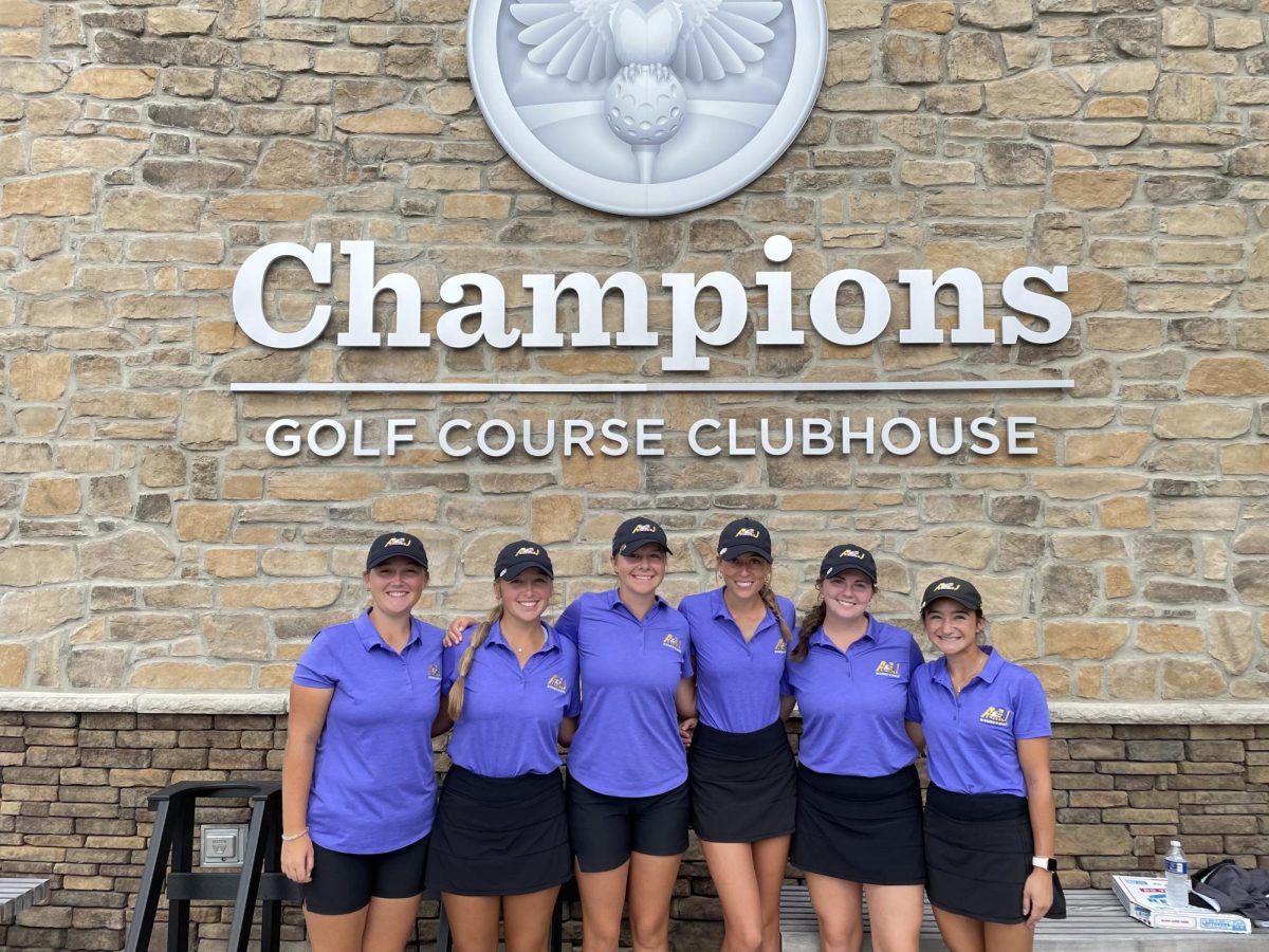 The womens golf team stands together after competing in their previous tournament.