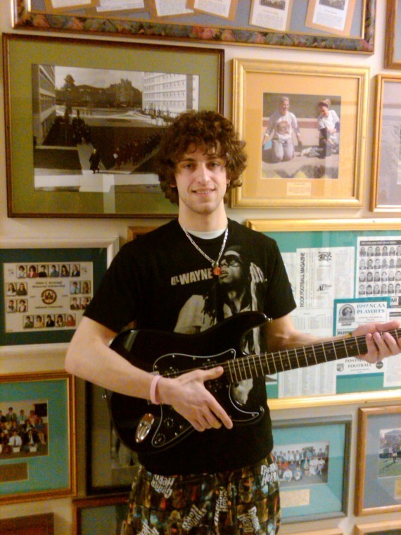 David Sheldon, a senior from the University of Mount Union, poses with his grand prize - a squire guitar - after winning the Ashland University Guitar Clubs first-ever Guitar Hero contest.