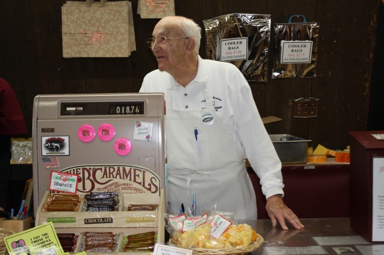 The infamous “Grandpa” of Grandpa’s Cheesebarn helps wait on a customer. 