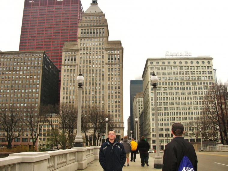 Josh Payne stands in front of sky-reaching towers in Chicago.