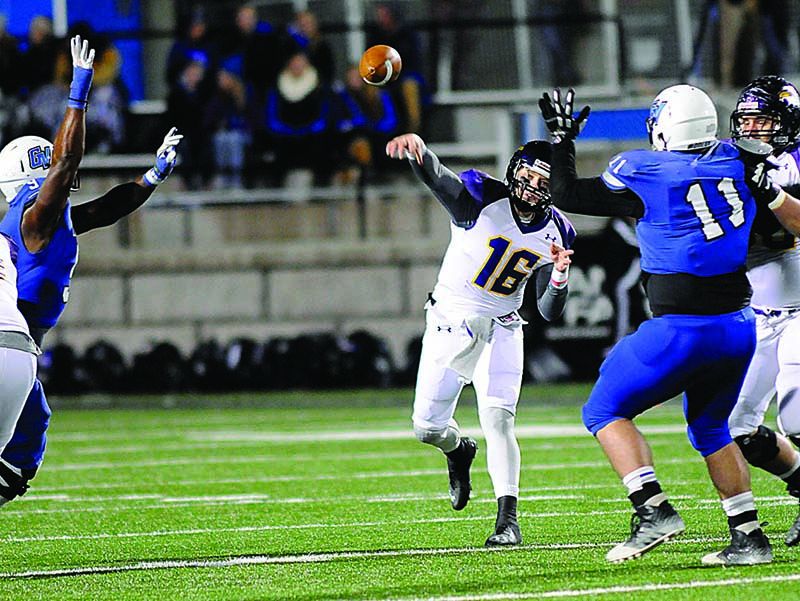 Ashland quarterback Travis Tarnowski throws a pass between two Grand Valley State defenders at Lubbers Stadium in Allendale, Mich. Tarnowski threw for 349 yards and two touchdowns in the 37-14 win.