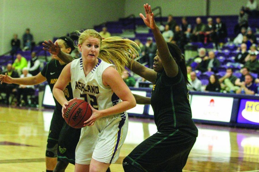 Sophomore Suzy Wollenhaupt looks to pass around Wayne States Shareta Brown during the teams game last week. The Eagles knocked off the No. 5 ranked Wayne State 84-68.