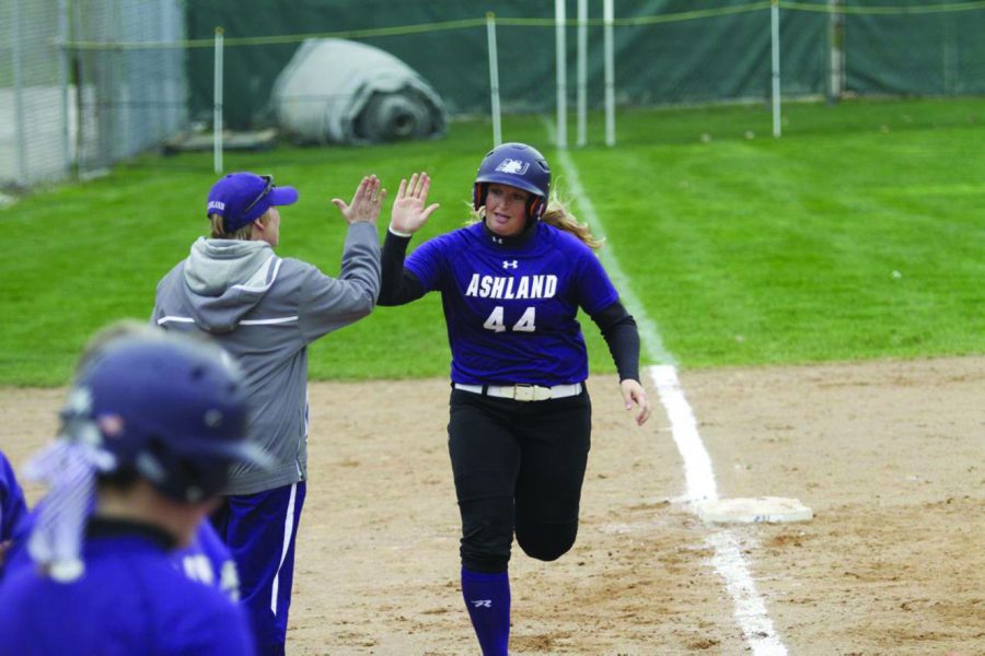 Junior Jennifer Moore rounds third after hitting a home run in the second game against Findlay
