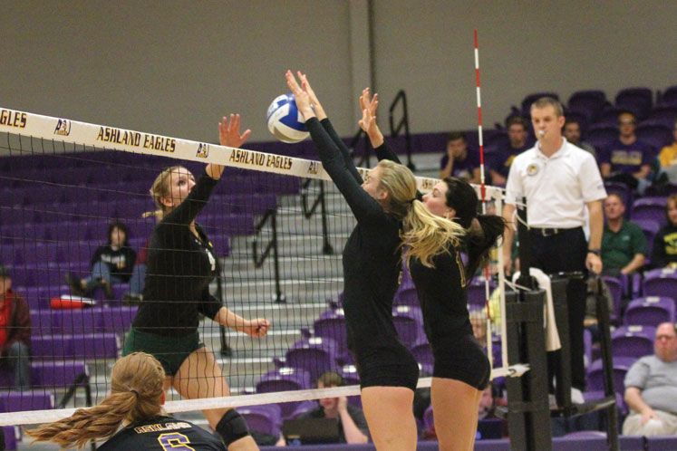 Senior Sam Zuber and junior Rylee Scott jump to block a Wayne State attack last season. Zuber and Scott are two of the returning players for the Eagles. 