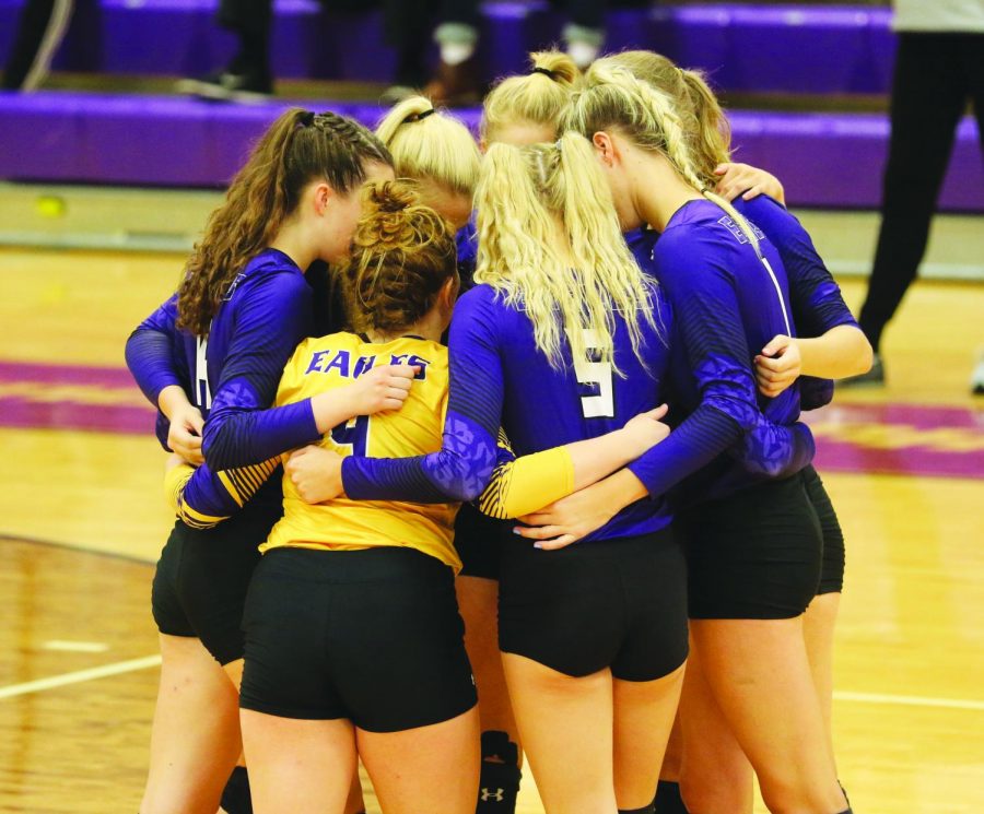 AU volleyball players huddle up before one of their matches earlier in the season.