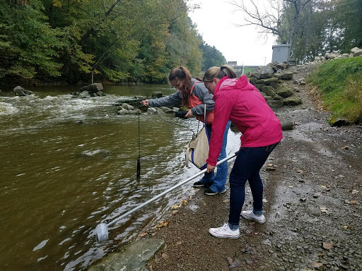 Ashland University students, Alexis Flagg (left) and Emily Fulk (right) track physical and chemical parameters and sample surface water in the Black Fork of the Mohican River, downstream from the Charles Mill Lake Dam.