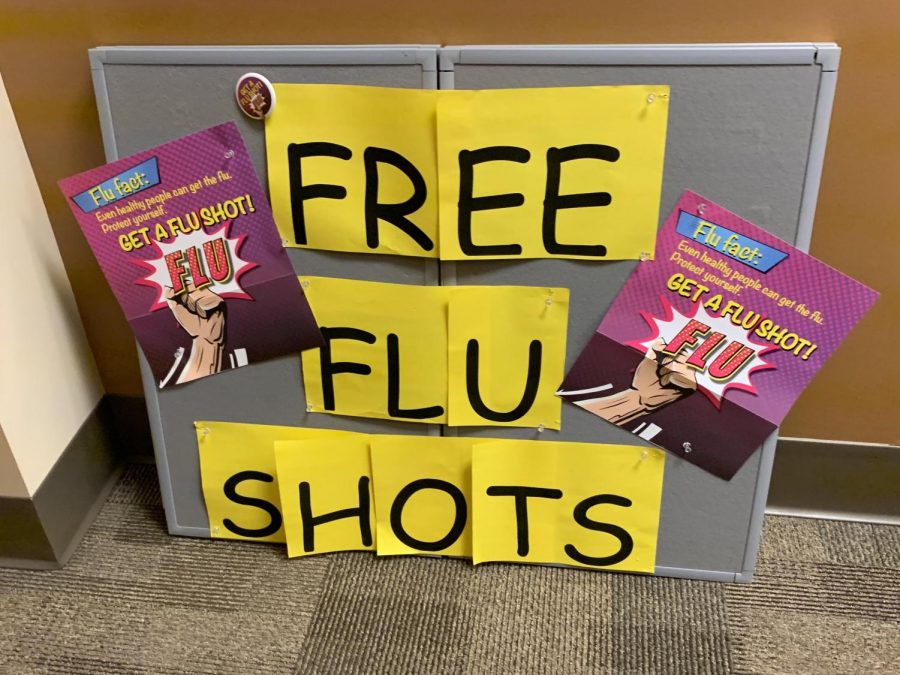 The free flu shots sign sits outside of the health room in the student center.