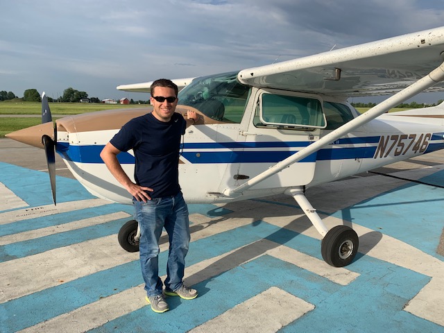 Justin Fletcher, a 2012 graduate of Ashland University, posing for a picture after his first solo flight.