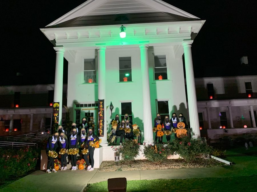 The AU cheer and dance team in front of the Old  Freer home for the annual pumpkin glow