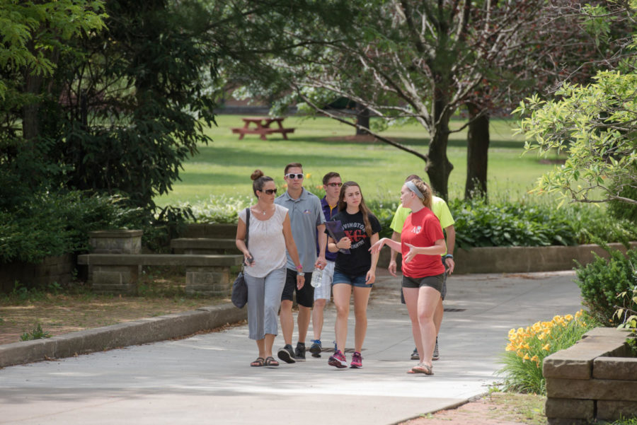 Prospective students are led by a tour guide during a campus visit.
