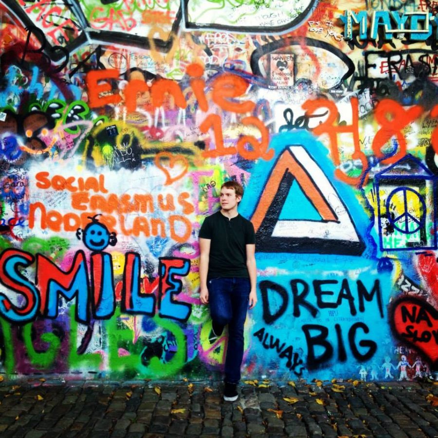 AU student standing in front of the Lennon Wall during Semester in Spain in 2014.