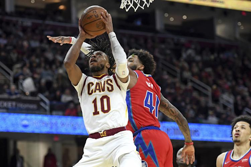 Cleveland Cavaliers point guard Darius Garland (10, white) drives for a layup against the Detroit Pistons’ Saddiq Bey (41, red) during the first half of the game on Saturday, March 19, 2022, at Rocket Mortgage Fieldhouse in Cleveland, Ohio. Garland finished with 24 points as the Cavs won the game 113-109. 