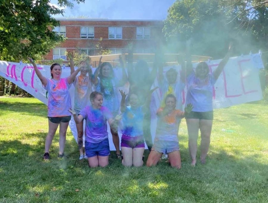 The+sisters+of+Delta+Zeta+smile+alongside+one+another+as+they+raise+money+through+their+pain+a+turtle+event+in+the+fall.+For+this+event%2C+students+buy+paint+to+throw+at+chapter+members+with+proceeds+supporting+their+hearing+and+speech+causes.