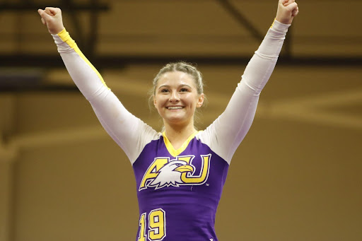 Junior Kaylee Reed smiles after successfully completing part of her routine.