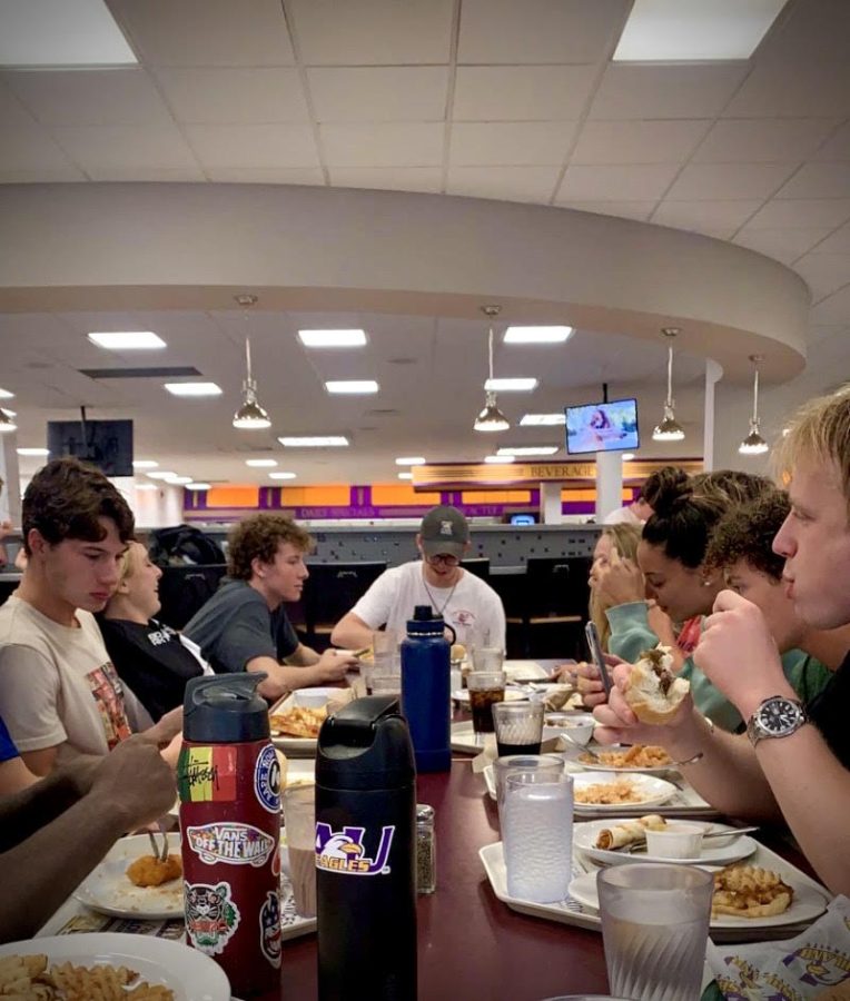 The AU Swim Team sits down for dinner. Updated practice times allow this to happen before or after any practices.