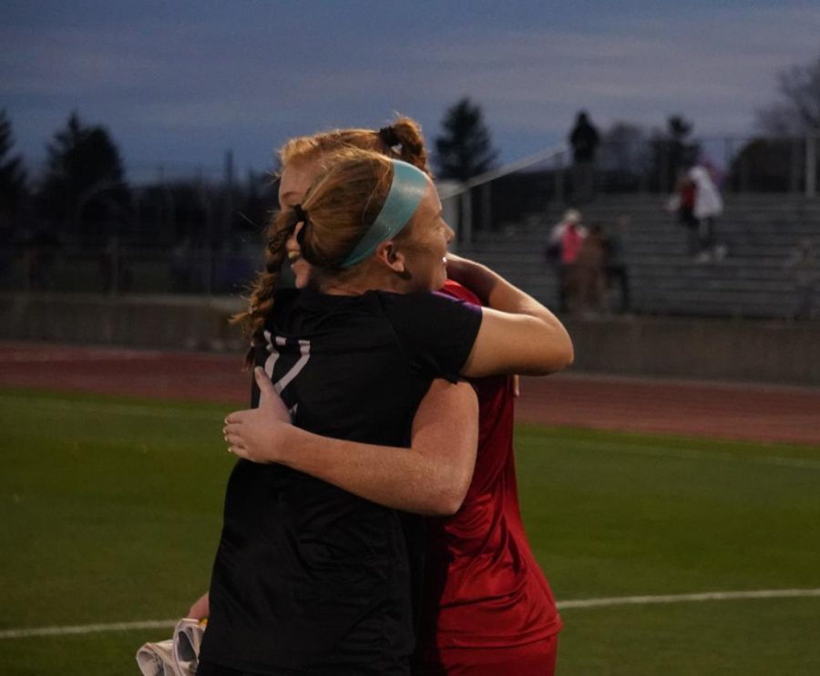 Goalkeeper Bri Rogers and midfielder Avery Rosso embrace one another after a hard fought game.