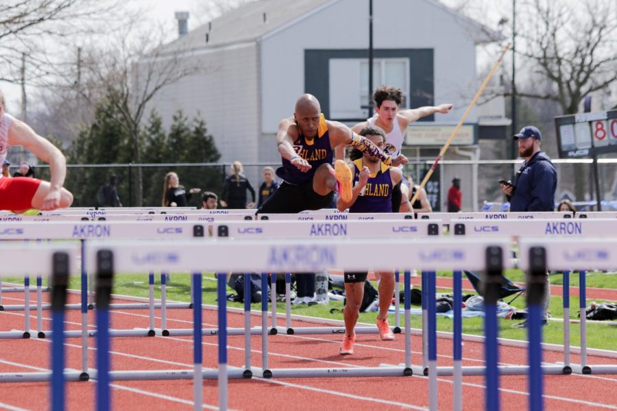 Hurdler T.J. Skinner competes in the Akron Quad meet, jumping over a hurdle.