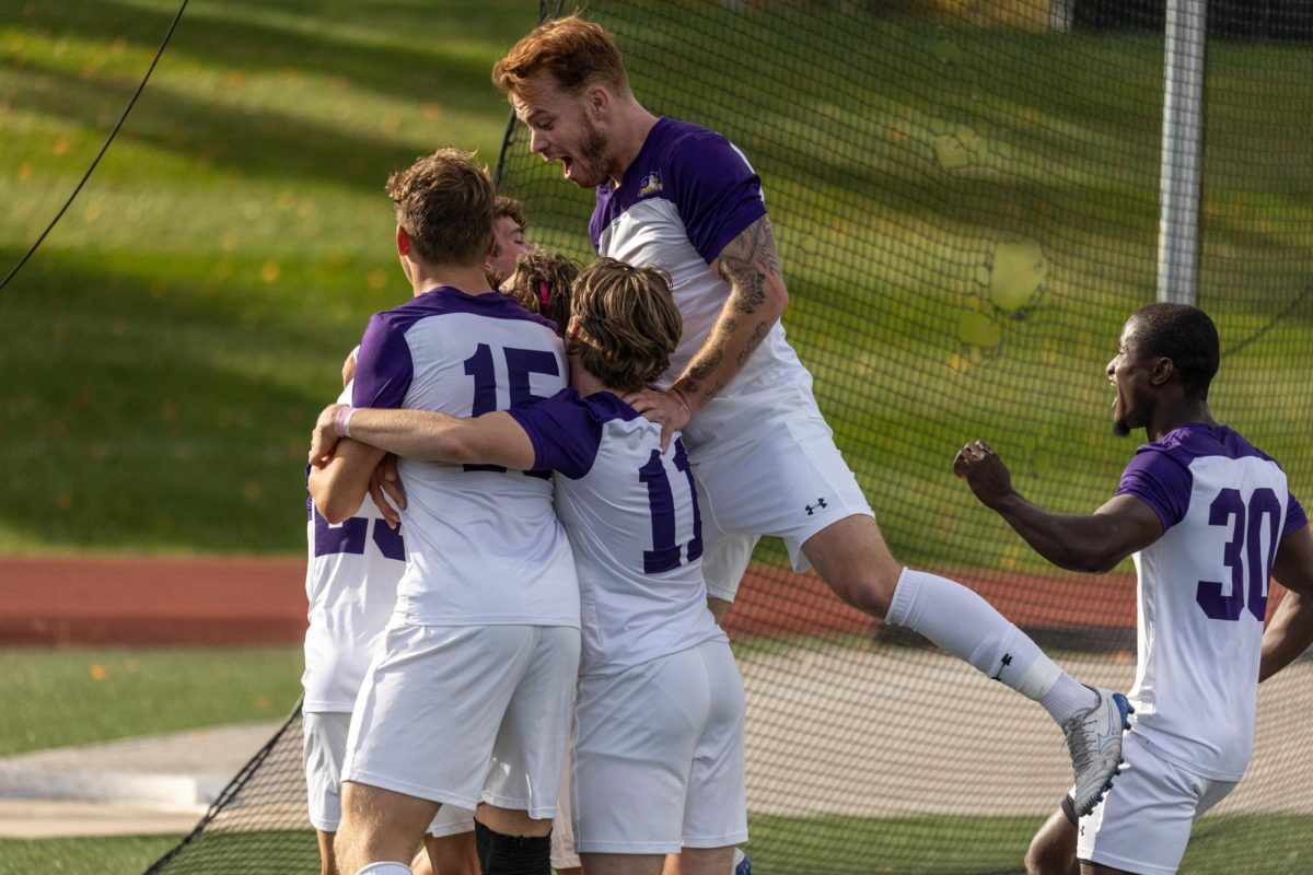 The Eagles celebrate after a goal scored against the Malone Pioneers during the 2022-23 fall season