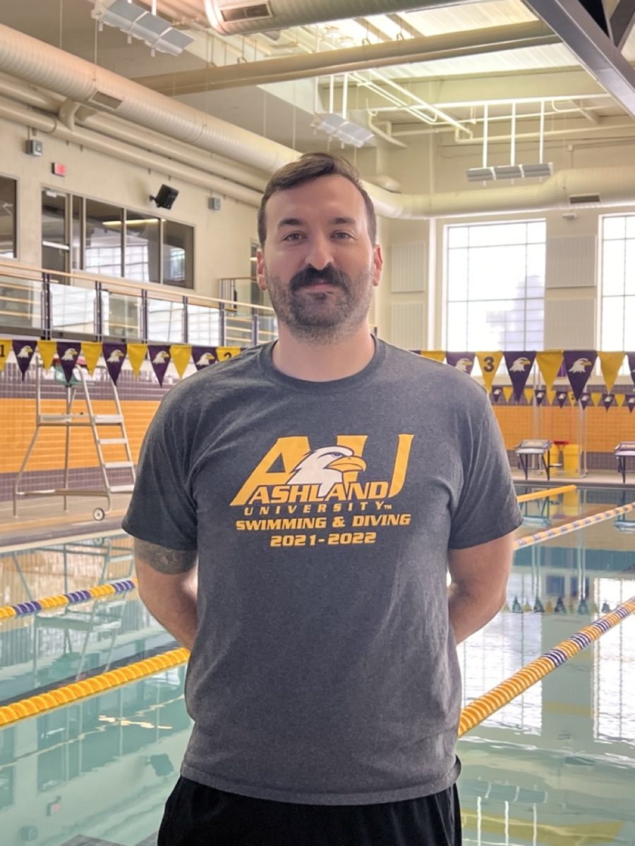 Eagle Interim Head Coach Hueston Holder stands in front of the AU pool.