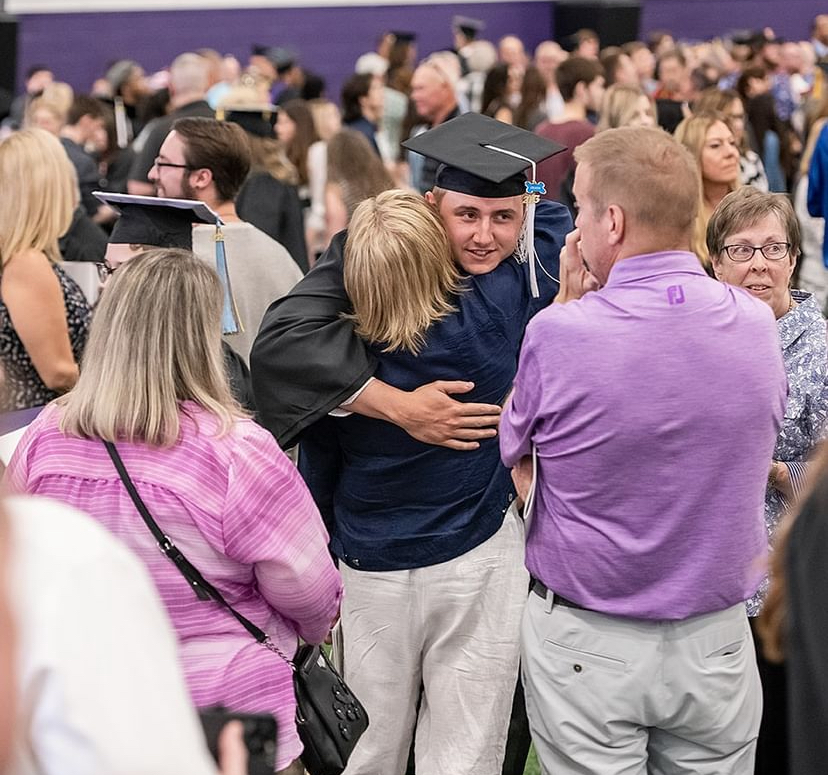 Students rejoice and embrace each other after graduating in the spring 2023 commencement.