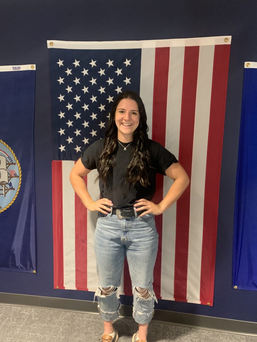 Anna Sanders pictured in front of an American Flag located in the study lounge of “The Jack” 