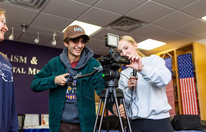 AU students, Lainey Kathrein and Aidan Nayak, work on producing content for the JDM Department.