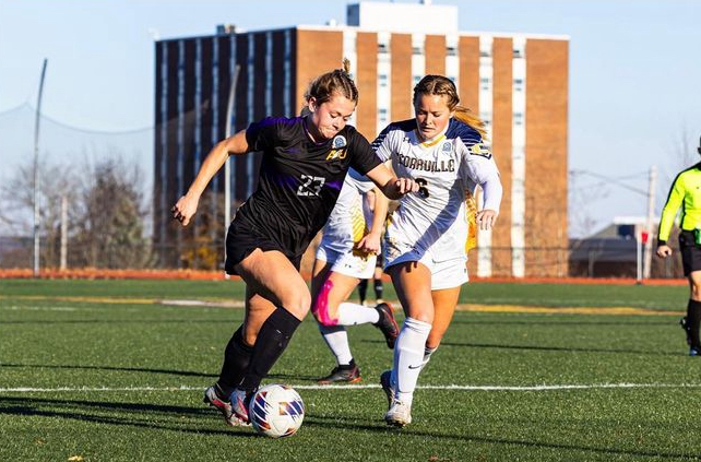 Eagle midfielder Ella Schneider dashes down the field with a Cedarville player trailing her.