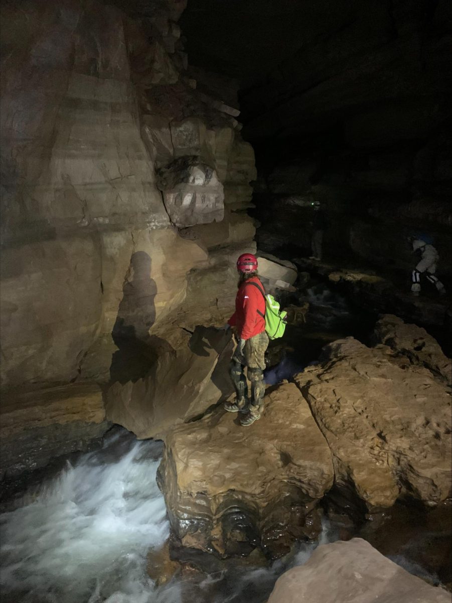 Brynn Meisse hikes through the cave in Elkins, West Virginia.