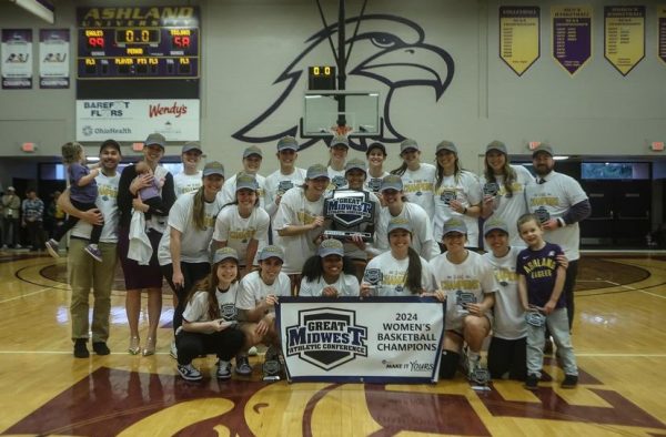 The Eagles celebrate at center court inside of Kates Gymnasium after winning the GMAC championship.