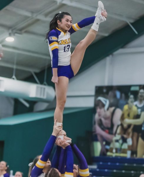 Flyer Lily Boldman does a routine for the Eagles. (Retrieved from AU STUNT)