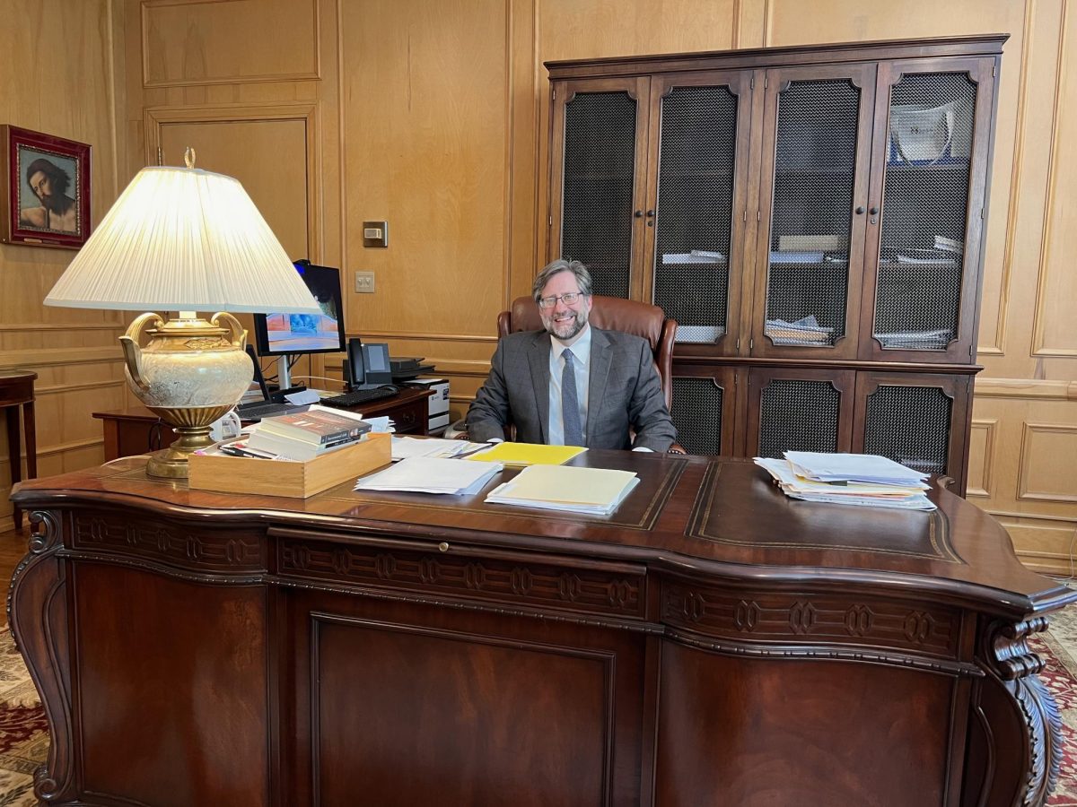 President Peede its at his desk in his office.