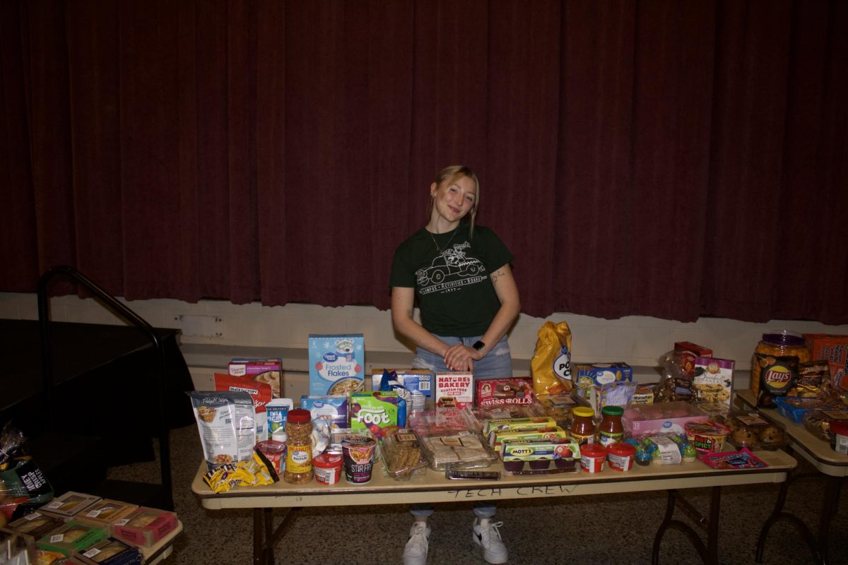 CAB board member showing off the food that is up to win