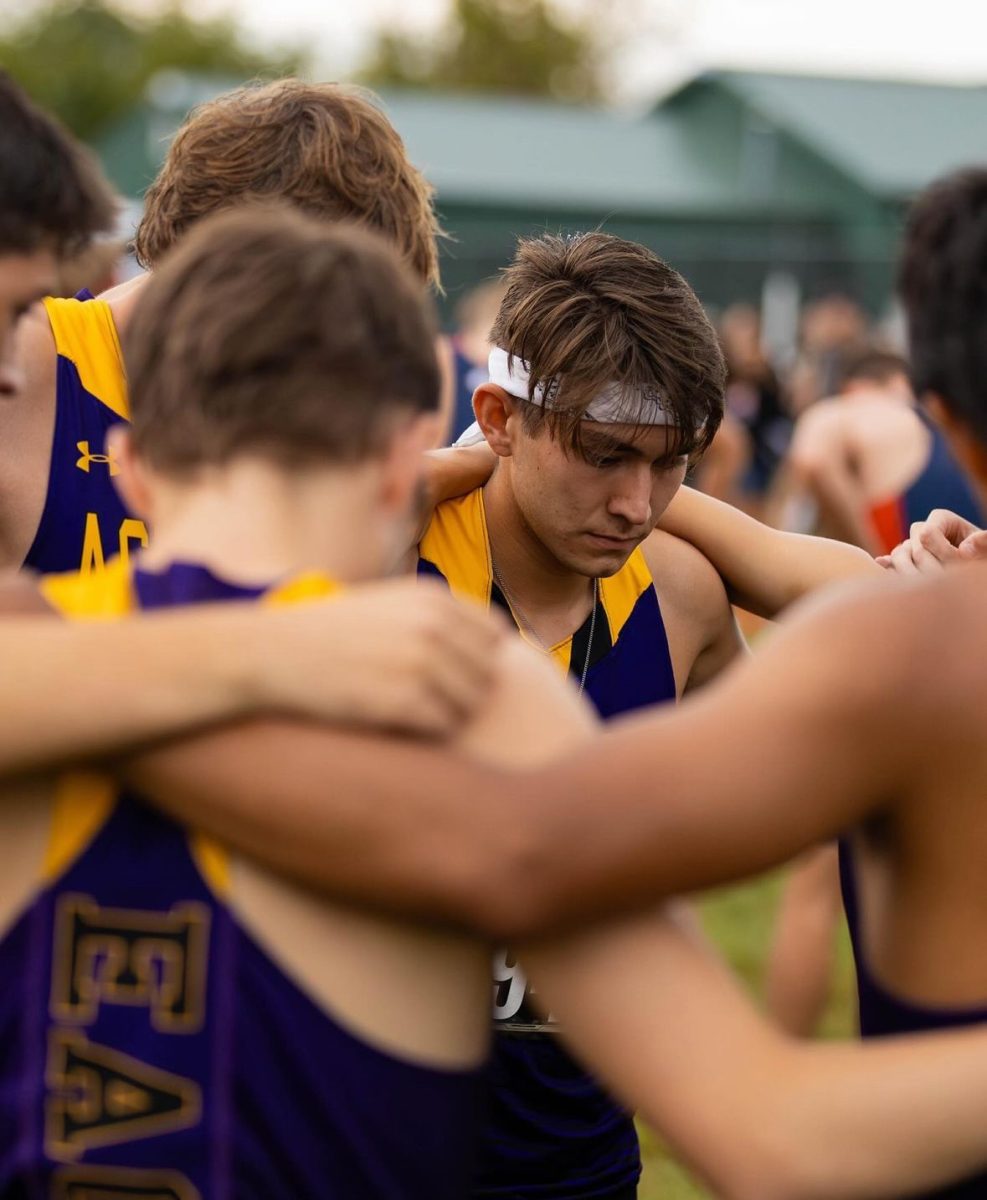 The AU cross country team stands together in a huddle before their race.