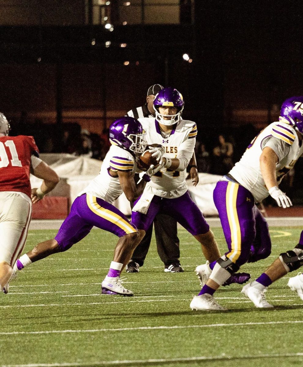 Eagle quarterback Trevor Bycznski hands the ball off.