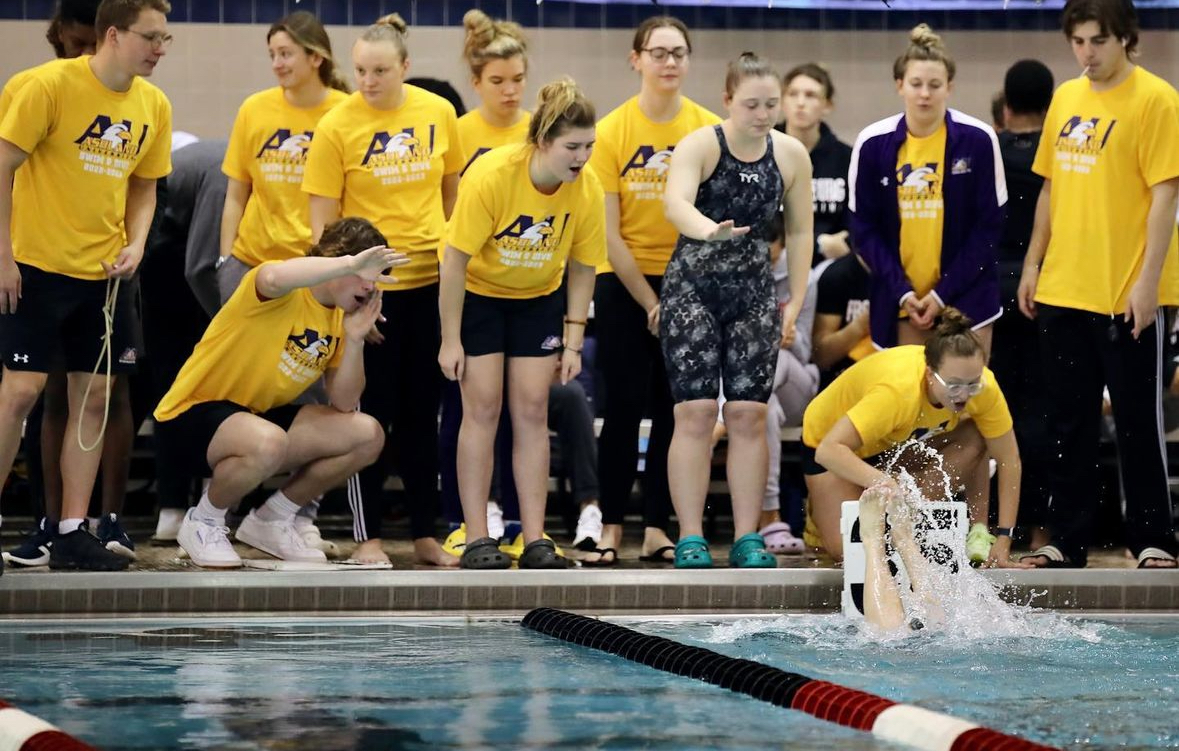 Swim and dive team cheering on teammates.