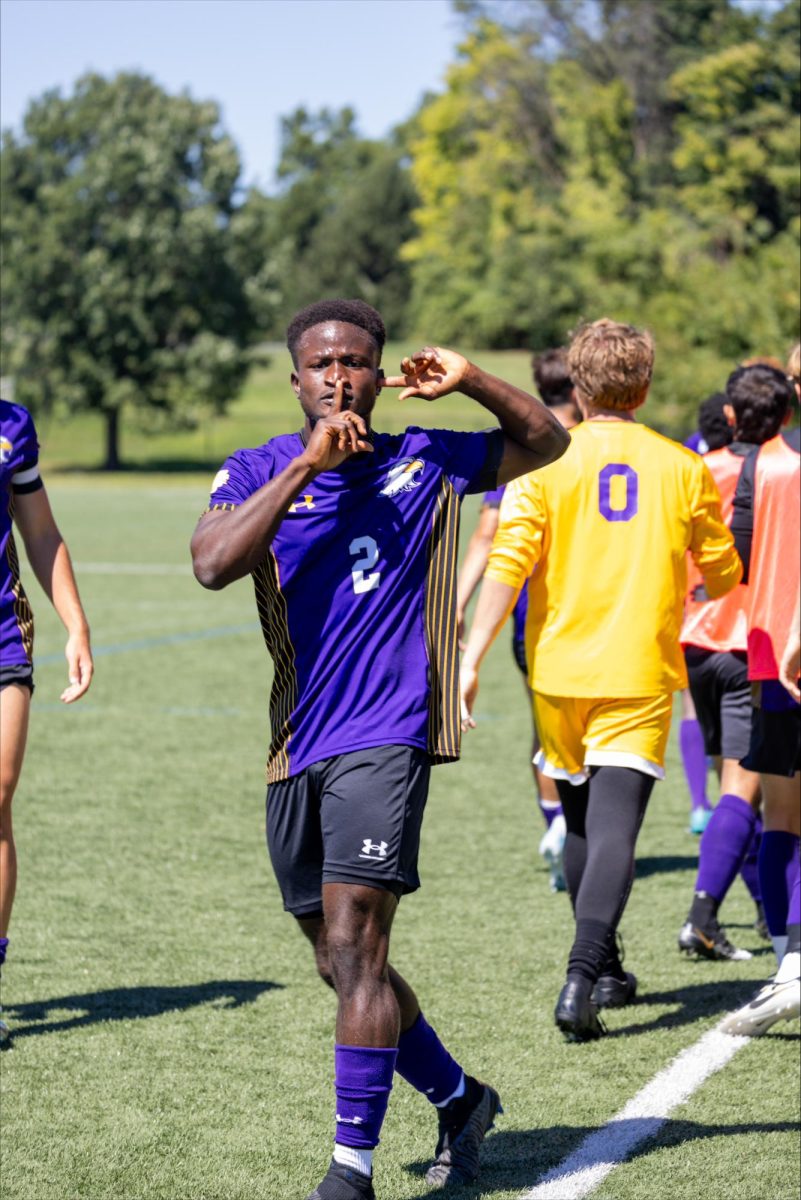 Thullah holds up his finger in silence after scoring a goal.