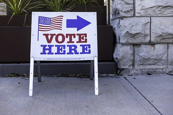 Voting sign outside of a building promoting citizens to vote.