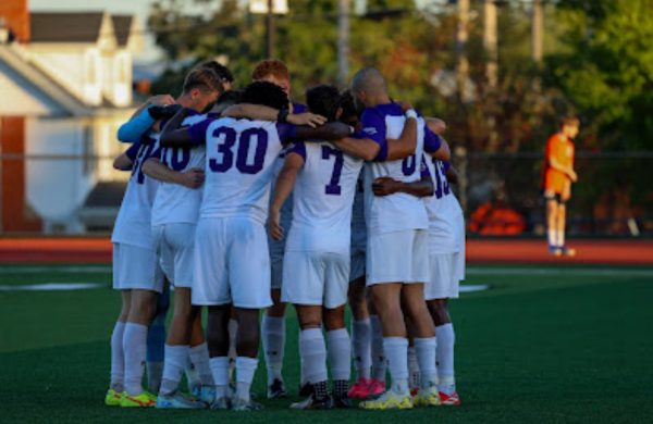 AU men’s soccer team huddled.
 