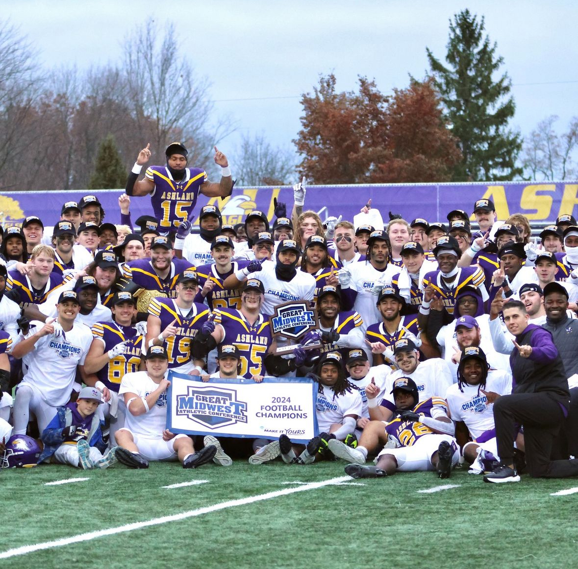 The Eagle football team celebrates in the middle of the field with the G-MAC title.