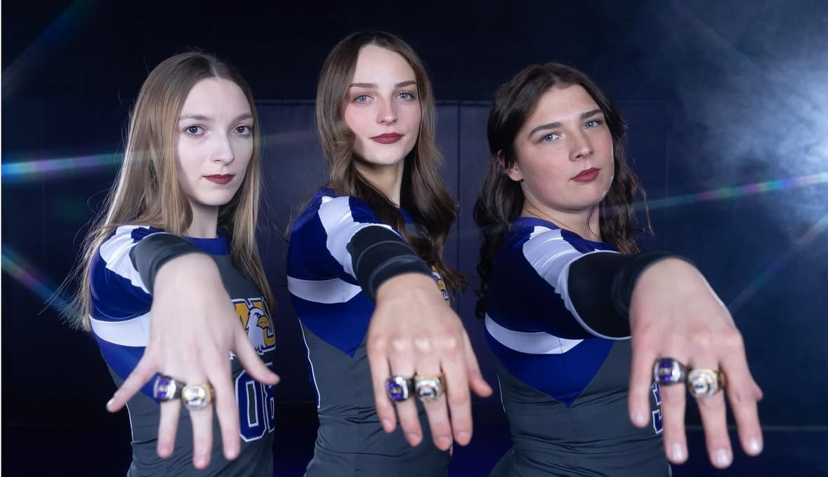 Adamas showing off conference rings with teammates Alyssa and Meghan