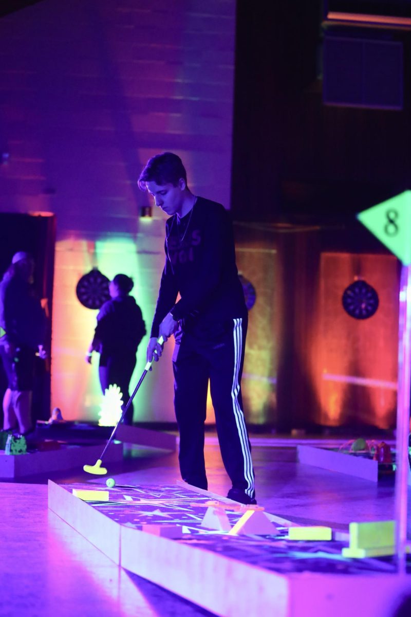 Lincoln Naylor playing glow-in-the-dark mini golf