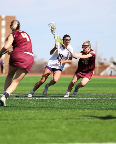 Tori Wanat charges the ball down the field as she defends herself against her opponent.