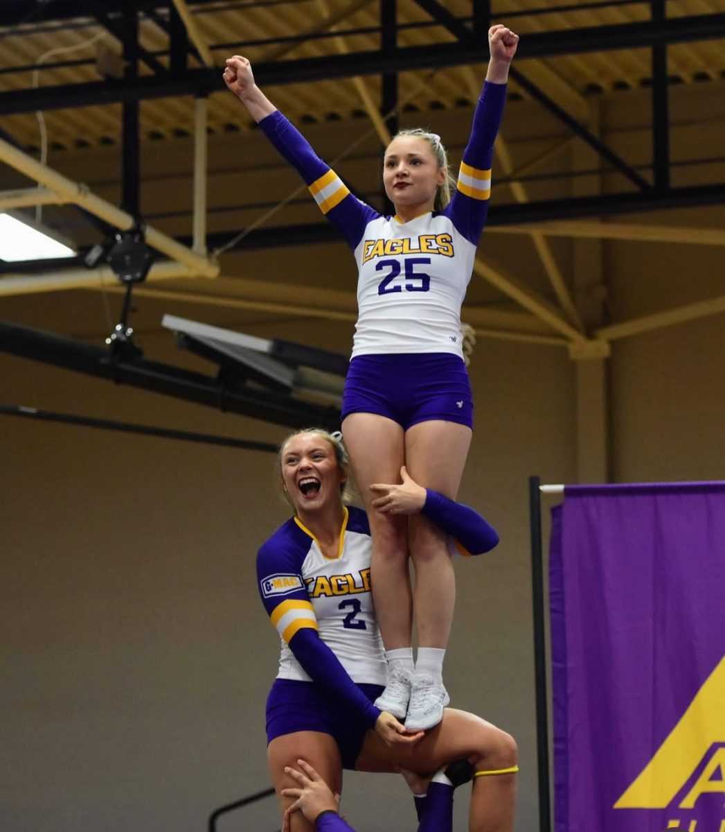 Eagles Chloe Colvin and Savanna Mahaffey achieving a perfect lift with spirted looks on their face.