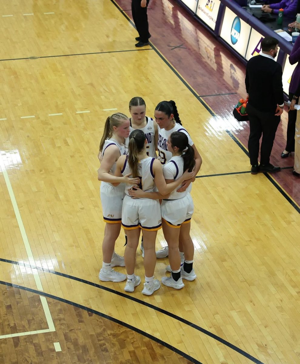 Eagles huddled up mid game discussing game plan in an intense matchup.