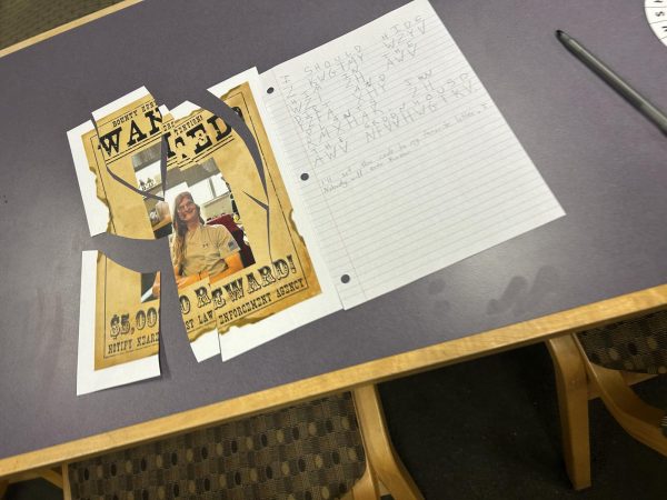 Close up of the note and wanted sign students had to figure out to solve the mystery. 
