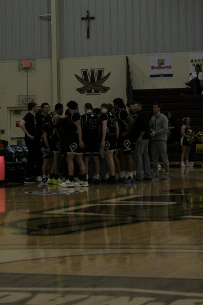 Team in a huddle preparing for the final few minutes of the game.  