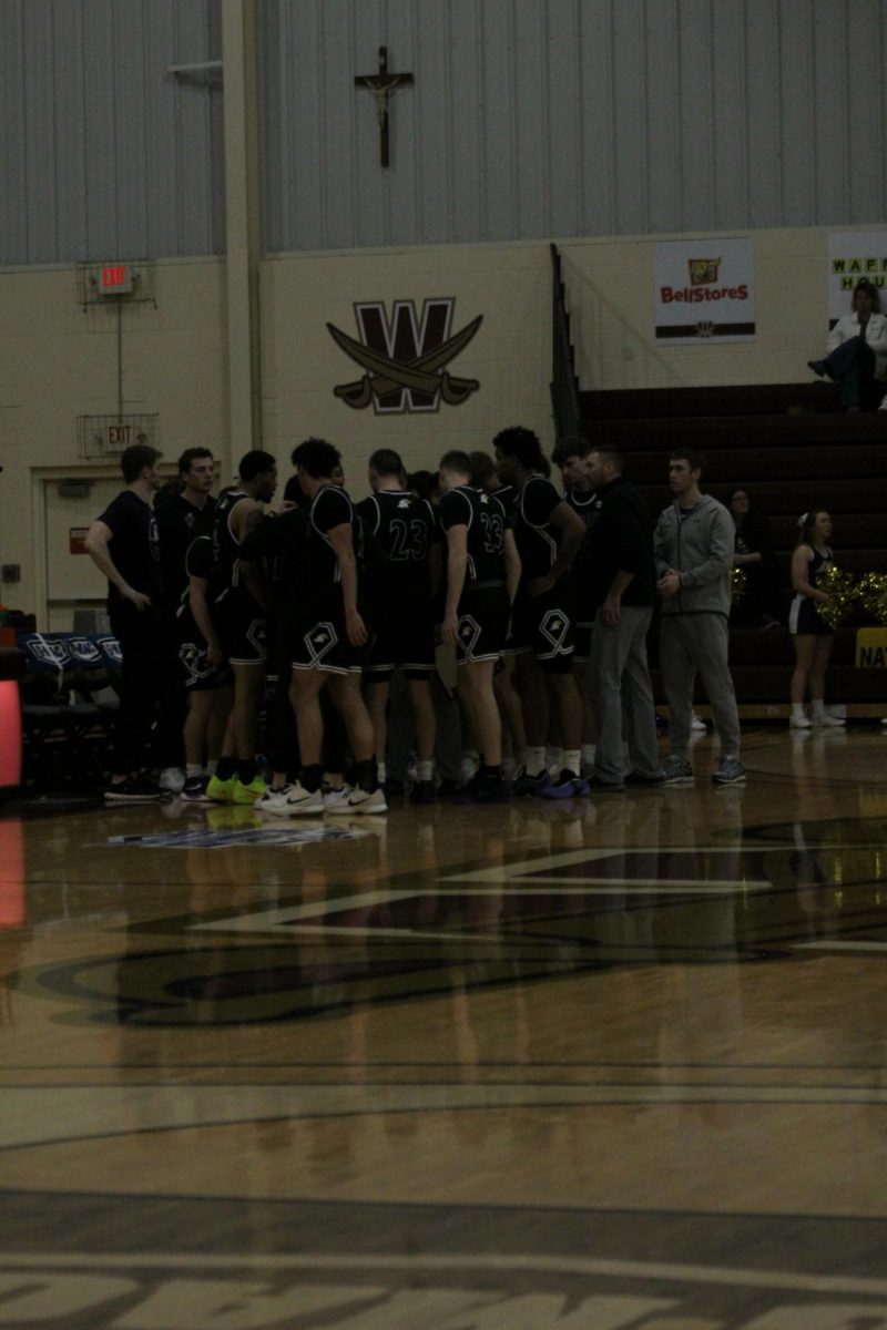 Team in a huddle preparing for the final few minutes of the game.  