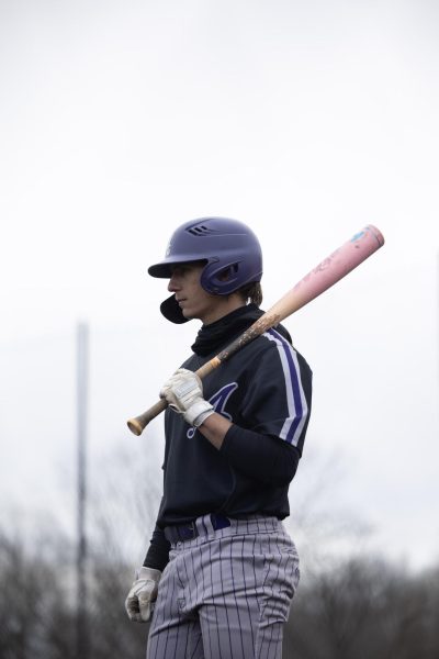 Graduate student Chris Franks waiting for his turn at bat.